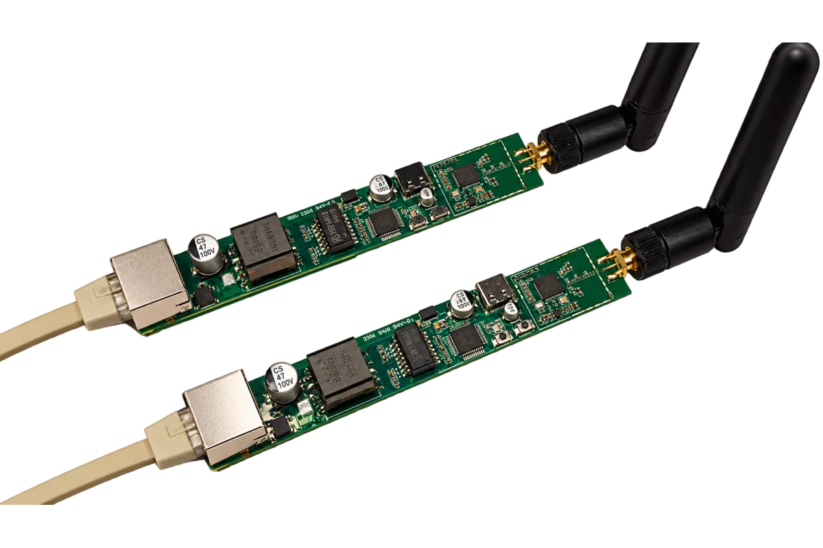 Two bare ZREL boards side by side: RJ45 jack with PoE magnetics at one end, USB-C in the middle, antenna connector at the other end.